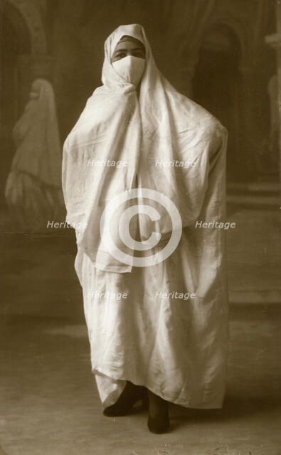Veiled woman, Algiers, Algeria, 1943. Artist: Unknown