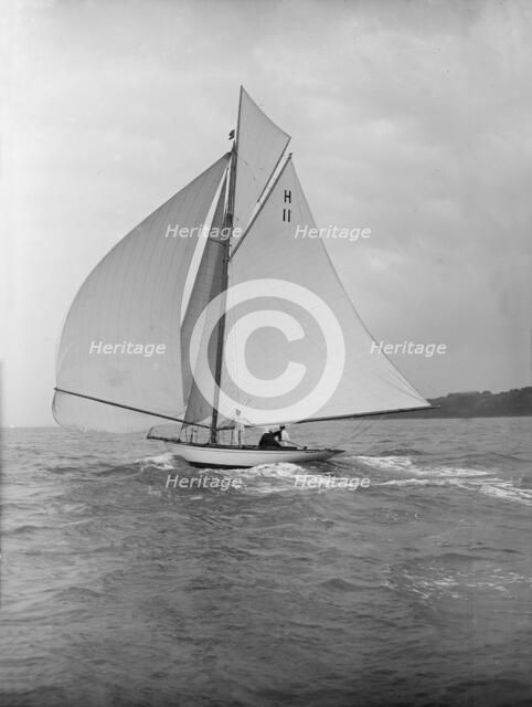 'Ventana' (H11), an early 8 Metre yacht, running downwind under spinnaker, 1913. Creator: Kirk & Sons of Cowes.