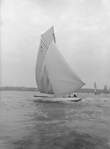 Ventana (H11), and early 8 Metre yacht, running downwind under spinnaker, 1913. Creator: Kirk & Sons of Cowes