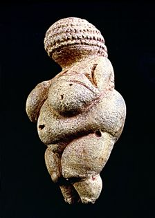 Venus of Willendorf 110 mm.: woman statue made in limestone and painted with ochre. It is rhomb…