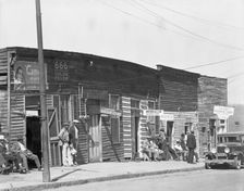 Vicksburg Negroes and shop front, Mississippi, 1936. Creator: Walker Evans