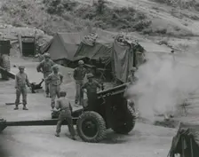 Vietnamese artillerymen fire from a mountain position during field training, 1962. Creator: United States Army