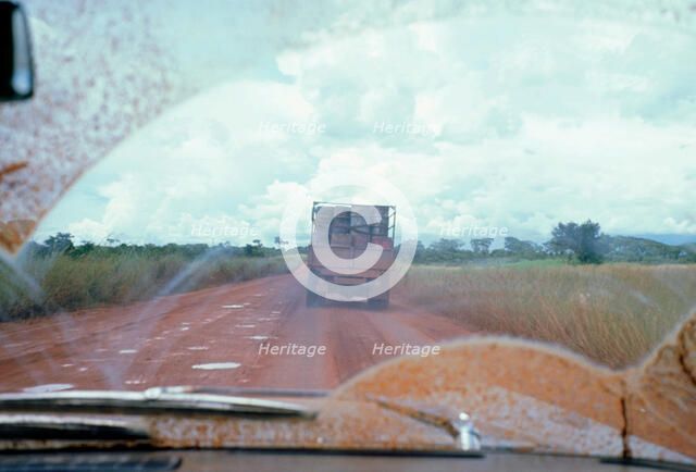 View through muddy windsreen on African dirt road. Artist: Unknown.