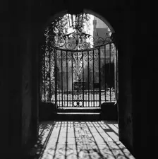 View through a decorative wrought iron gate in the Little Cloister at Westminster Abbey, 1946-1999. Creator: John Gay