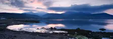 View across Brodick Bay to Beinn Tarsuinn and Goatfell at sunset, Arran, North Ayrshire, Scotland. Creator: Peter Thompson