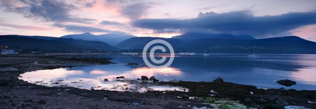 View across Brodick Bay to Beinn Tarsuinn and Goatfell at sunset, Arran, North Ayrshire, Scotland.