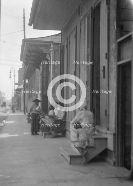 View down a sidewalk, New Orleans, between 1920 and 1926. Creator: Arnold Genthe.