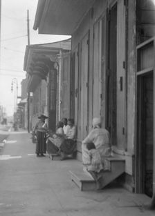 View down a sidewalk, New Orleans, between 1920 and 1926. Creator: Arnold Genthe