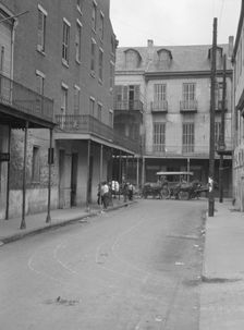 View down a street, New Orleans, between 1920 and 1926. Creator: Arnold Genthe