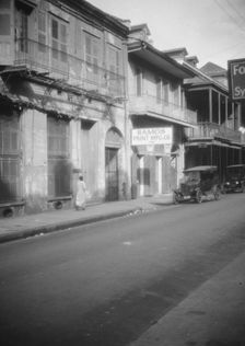 View down a street, New Orleans, between 1920 and 1926. Creator: Arnold Genthe