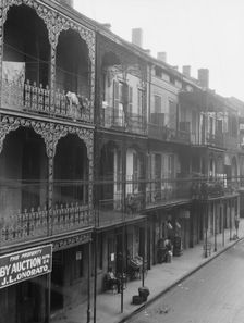 View down a street, New Orleans, between 1920 and 1926. Creator: Arnold Genthe