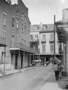 View down a street, New Orleans, between 1920 and 1926. Creator: Arnold Genthe