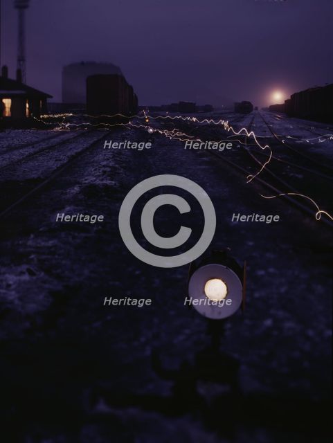 View in a departure yard at C & NW RR's Proviso (?) yard at twilight, Chicago, Ill., 1942. Creator: Jack Delano.