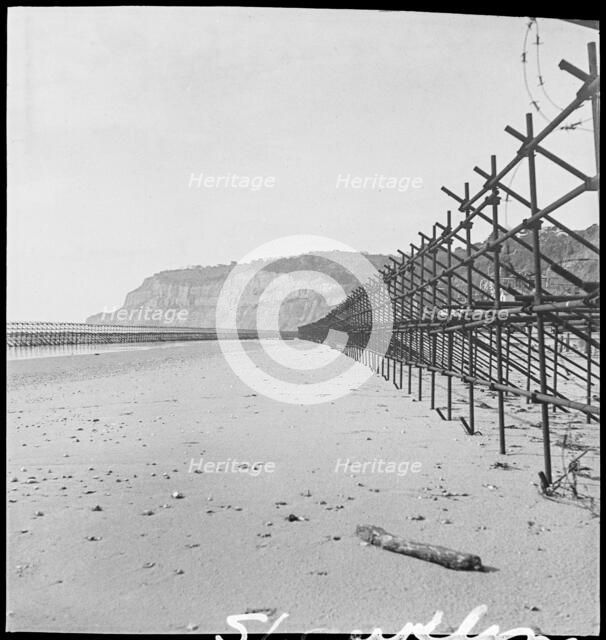 View looking south along the beach at Shanklin, showing Admiralty scaffolding, Isle Of Wight, 1945. Creator: George R Long.