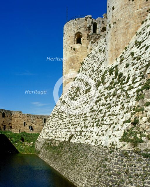View of walls and moat, Krak des Chevaliers, Talkalakh District, Syria Arab Republic, 1999.  Creator: LTL.