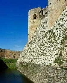 View of walls and moat, Krak des Chevaliers, Talkalakh District, Syria Arab Republic, 1999. Creator: LTL