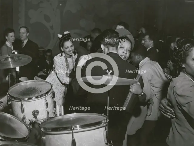 View of crowd dancing to the music of "Red" Sounders and his band, at the Club DeLisa..., April 1942 Creator: Jack Delano.