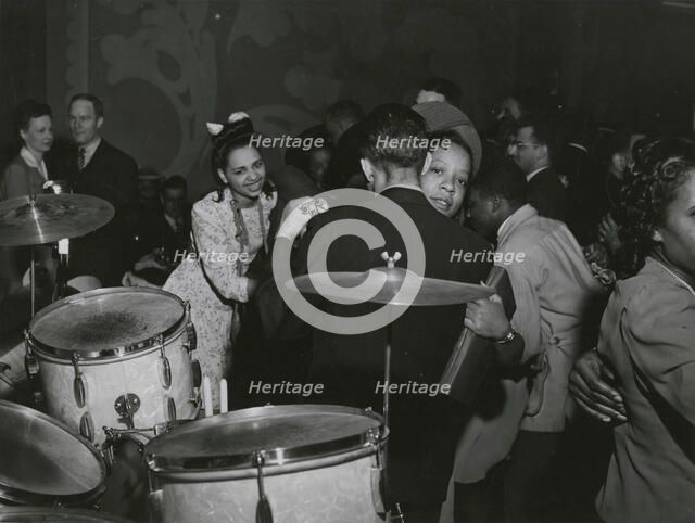 View of crowd dancing to the music of "Red" Sounders and his band, at the Club DeLisa..., April 1942 Creator: Jack Delano.