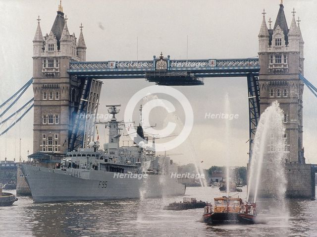 View of HMS London sailing beneath Tower Bridge, London, 1988. Artist: Anon