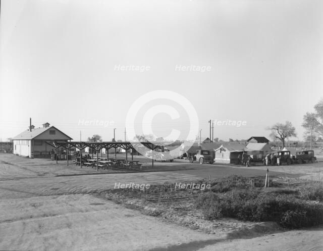 View of Kern migrant camp showing outdoor clubroom with protection from the sun, California, 1936. Creator: Dorothea Lange.