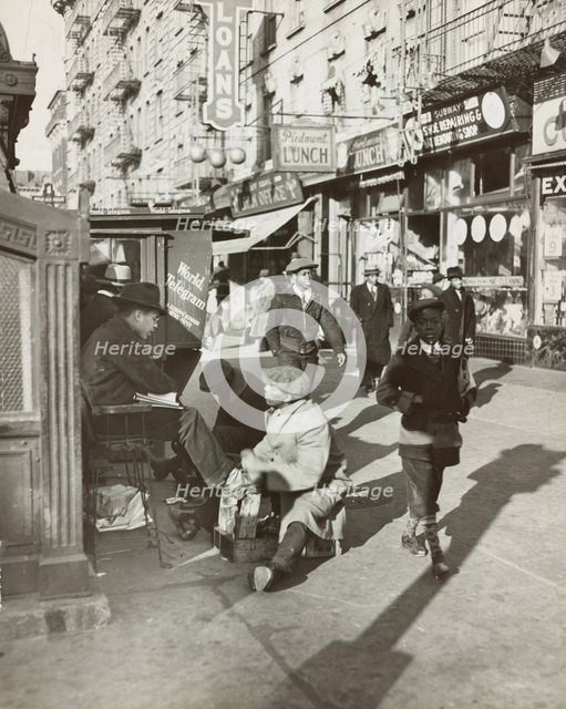 View of Lenox Avenue, Harlem, at 135th Street, showing businesses, pedestrians and..., 1939. Creator: Unknown.