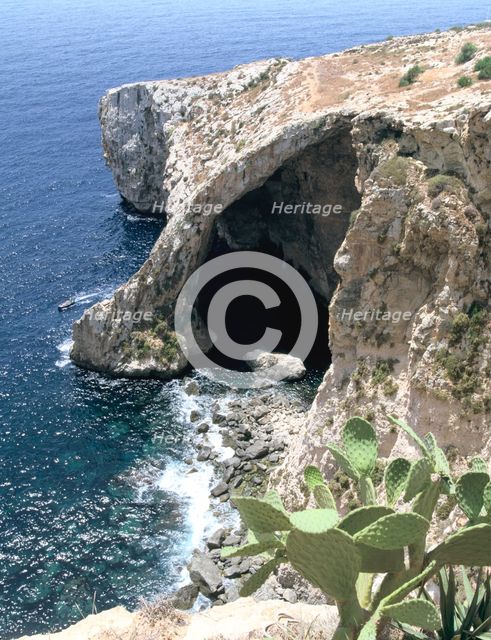 View of natural bridge and boat, Blue Grotto, Malta. Creator: Peter Thompson.