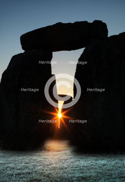 View of Stonehenge, showing the sun's rays glinting through the opening in a trilithon, 2012. Creator: James O Davies.