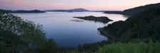 View over Seil Sound to a salmon farm and Luing, Slate Islands, Argyll and Bute, Scotland. Creator: Peter Thompson