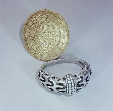 Viking silver arm ring and gold brooch, Hornelund, Denmark, 10th century. Artist: Werner Forman