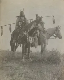 Village criers on horseback, Bird On the Ground and Forked Iron, Crow Indians, Montana, c1908. Creator: Edward Sheriff Curtis