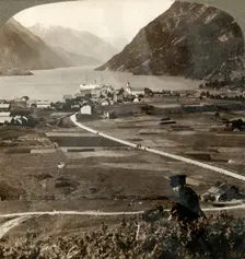 Village roofs and sunny fields of Odde, N. up the narrow mountain-walled Sorfjord, Norway 1905. Creator: Unknown