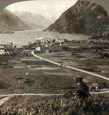 Village roofs and sunny fields of Odde, N. up the narrow mountain-walled Sorfjord, Norway 1905. Creator: Unknown