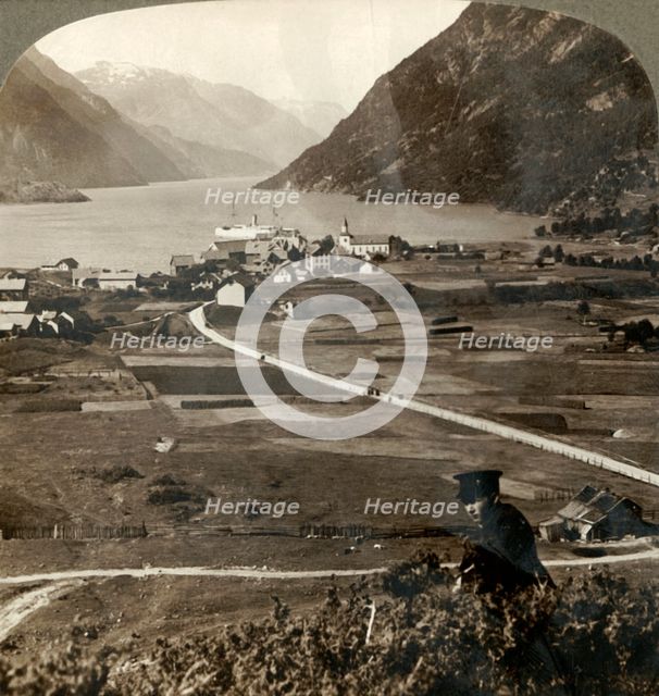 'Village roofs and sunny fields of Odde, N. up the narrow mountain-walled Sorfjord, Norway', 1905. Creator: Unknown.