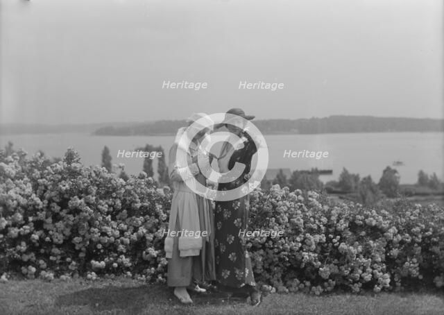 Viola Kraus and Helen Freeman standing outdoors, 1915 June. Creator: Arnold Genthe.