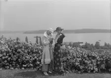 Viola Kraus and Helen Freeman standing outdoors, 1915 June. Creator: Arnold Genthe
