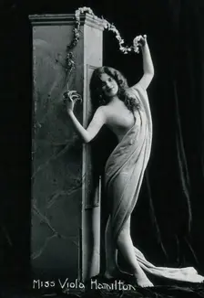 Viola Hamilton, posing in a classical attitude against a square column, early 20th century. Creator: Unknown
