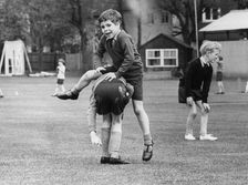 Viscount Linley playing leap frog with one of his classmates.. Creator: Unknown