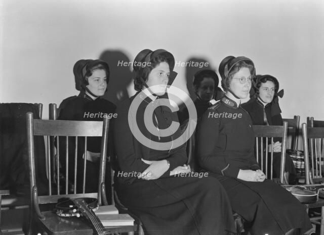 Visiting lassies sit on rostrom, Salvation Army, San Francisco, California, 1939. Creator: Dorothea Lange.