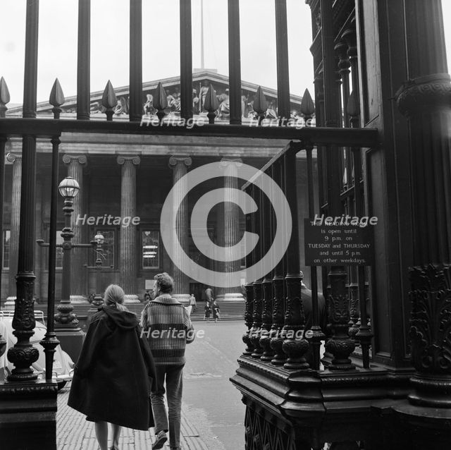 Visitors around the wrought iron gates at the south entrance to the British Museum, London, 1962-65. Creator: John Gay.