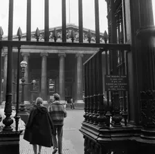 Visitors around the wrought iron gates at the south entrance to the British Museum, London, 1962-65. Creator: John Gay