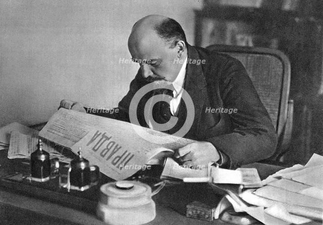 Vladimir Ilyich Ulyanov (Lenin), Russian Bolshevik revolutionary, reading Pravda, 1918. Artist: Unknown