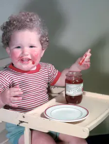 Young child eating P Hartley's Red Plum Jam and bread, c1955. Creator: Arthur Charles Kirby Ware