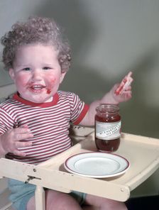 Young child eating P Hartley's Red Plum Jam and bread, c1955. Creator: Arthur Charles Kirby Ware