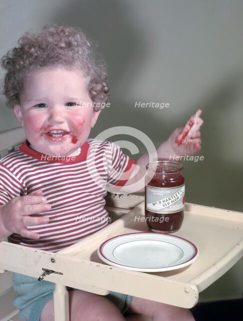 Young child eating P Hartley's Red Plum Jam and bread, c1955.  Creator: Arthur Charles Kirby Ware.
