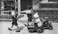 Young children playing in the street, London, 1926-1927