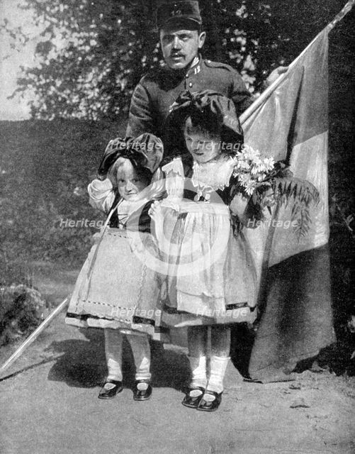 Young Alsatian children in traditional dress with a French soldier, World War I, 1915. Artist: Unknown