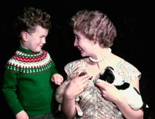 Young boy and woman holding two puppies, c1955-1965. Creator: Arthur Charles Kirby Ware