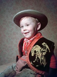 Young boy in a cowboy outfit, c1955. Creator: Arthur Charles Kirby Ware
