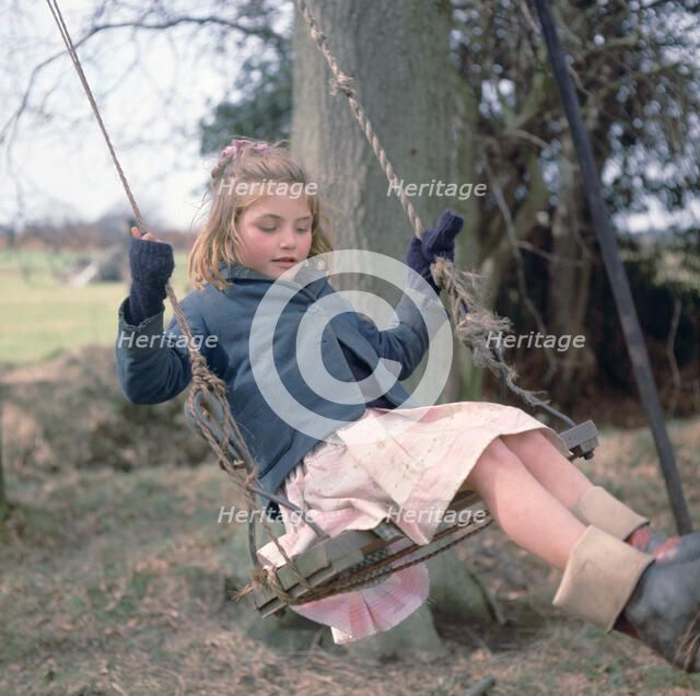 Young gipsy girl on a swing, Charlwood, Newdigate area, Surrey, 1964.