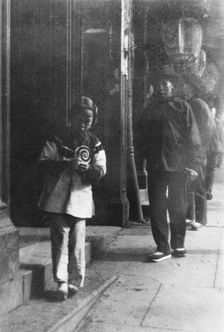 Young girl walking down a street, Chinatown, San Francisco, between 1896 and 1906. Creator: Arnold Genthe